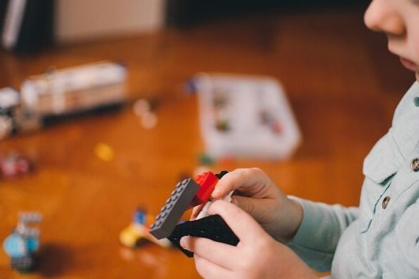 preschooler playing with lego